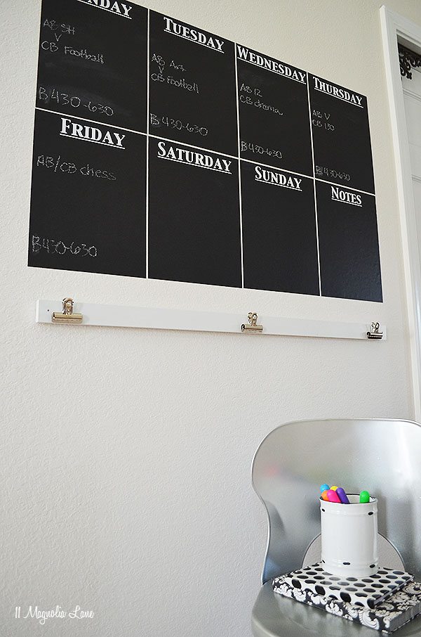 A calendar on the wall with the days of the week.