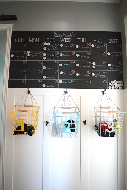 Wire metal baskets hanging from a calendar.
