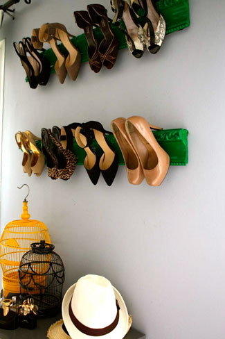 A hanging shoe rack with high heels on it.
