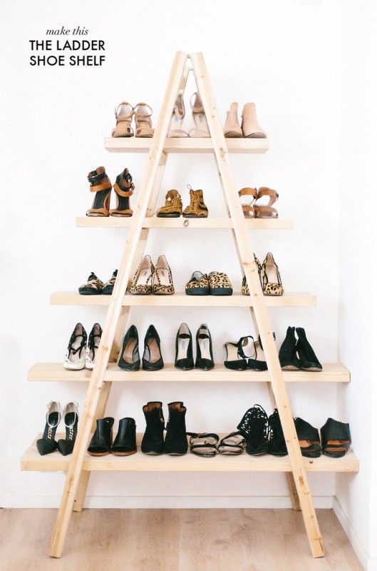 A multi tiered ladder forming an A with shoes on each tier.