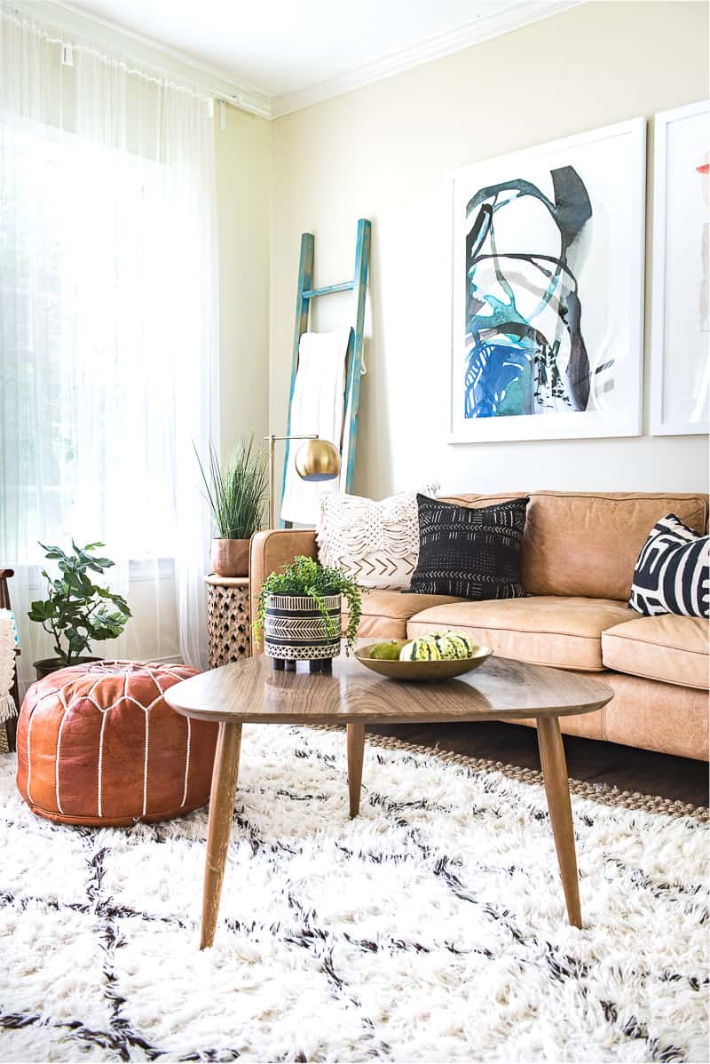 A small table in front of a brown couch.