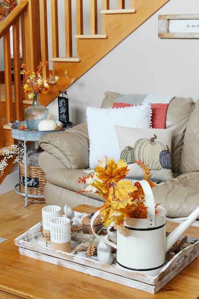 Fall leaves decorate a living room in vases.