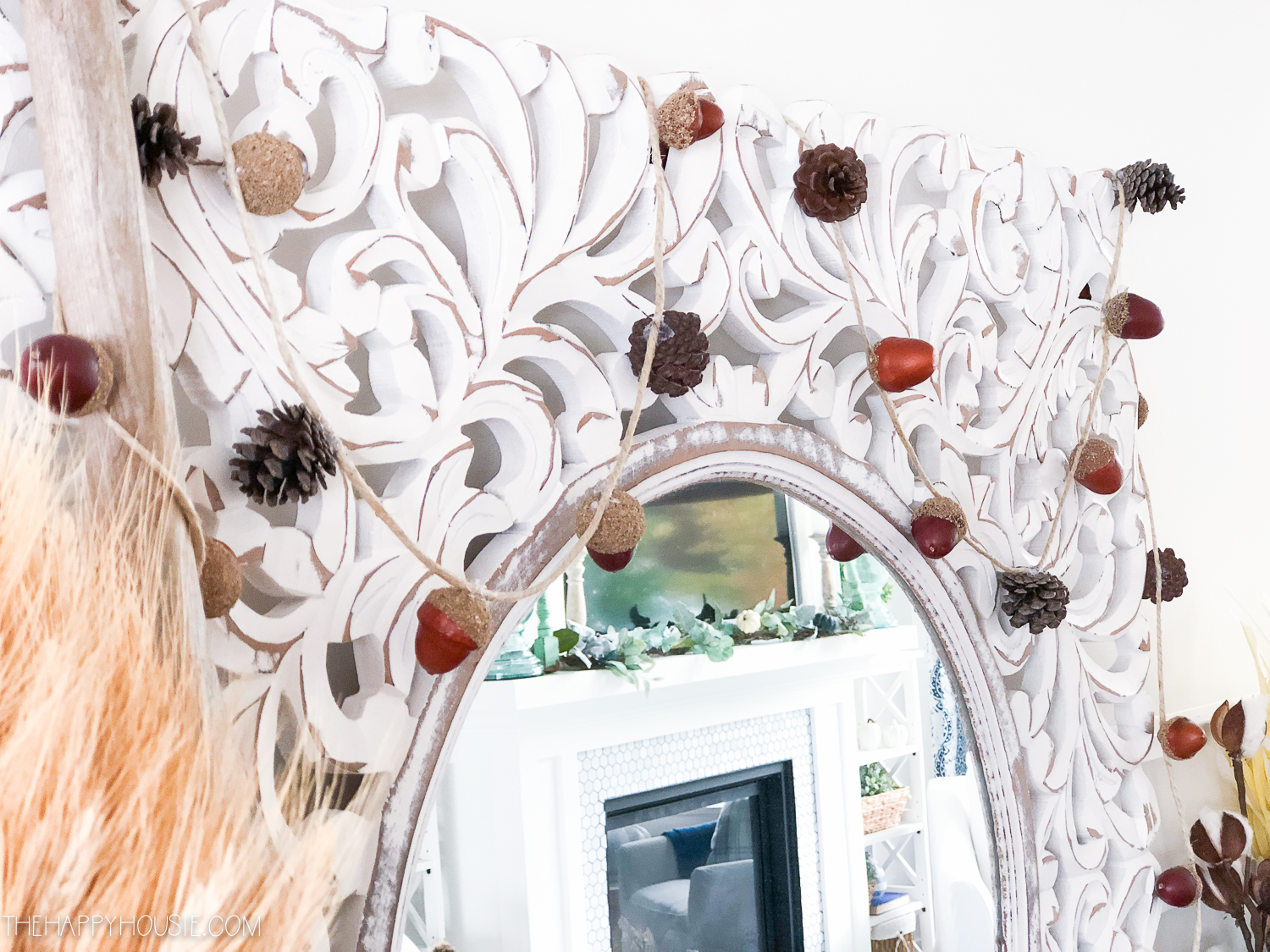 The strung up acorns and pinecones on the mirror.