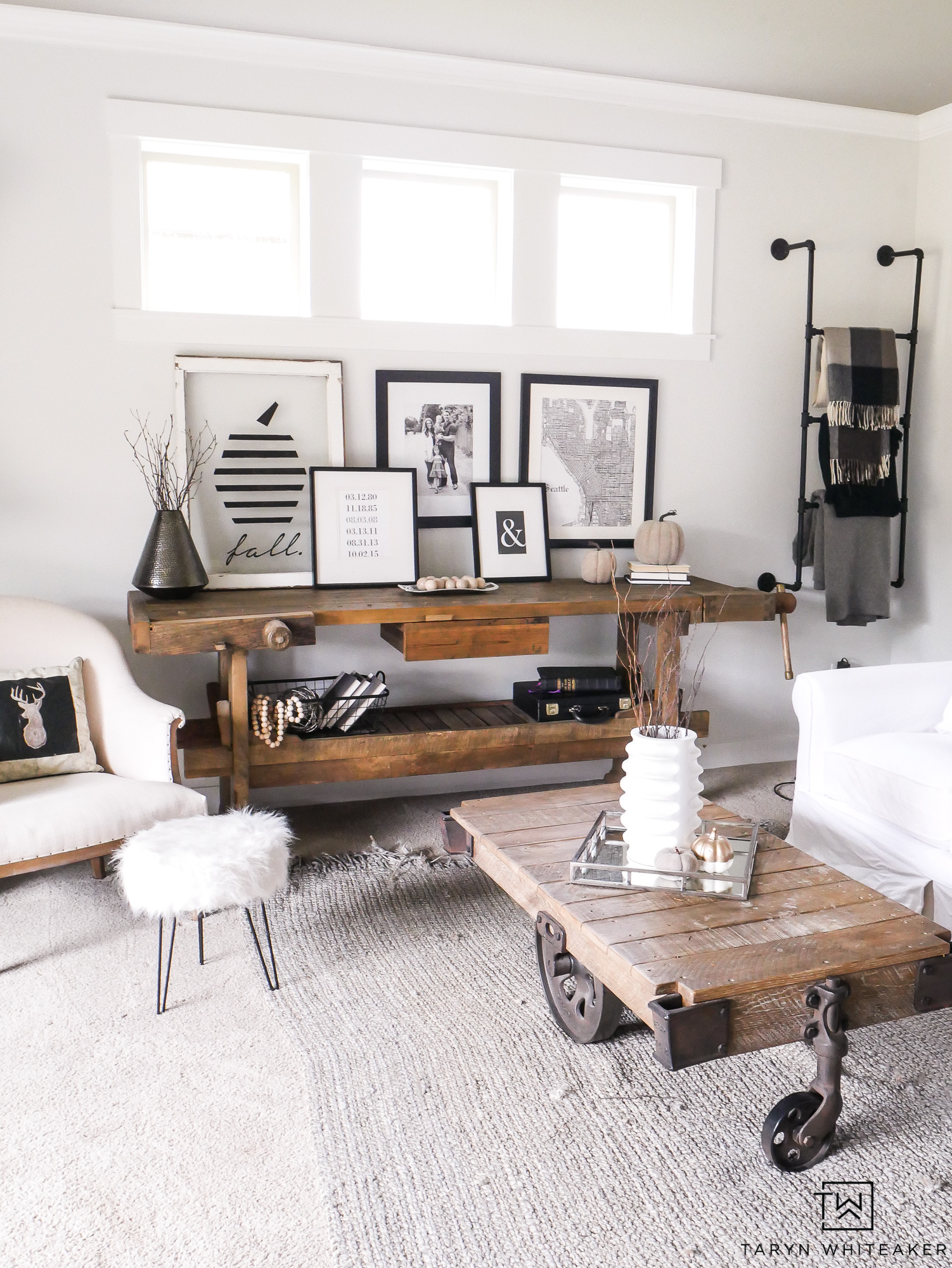A wooden shelf, plus a wooden coffee table in front of a white couch.
