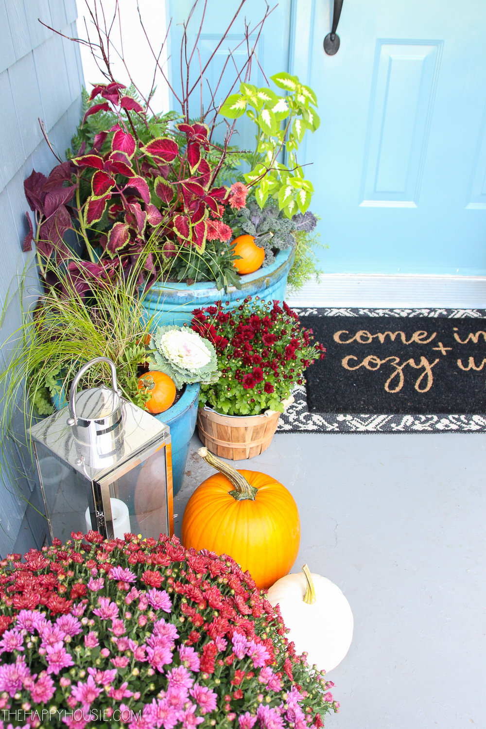 A small porch decorated for fall.