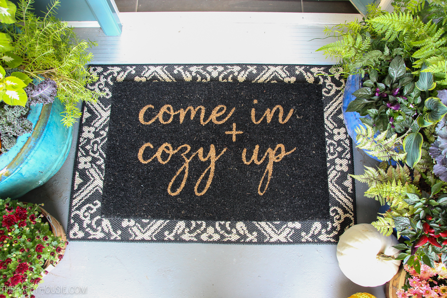The rug on the porch that says come in and cozy up.