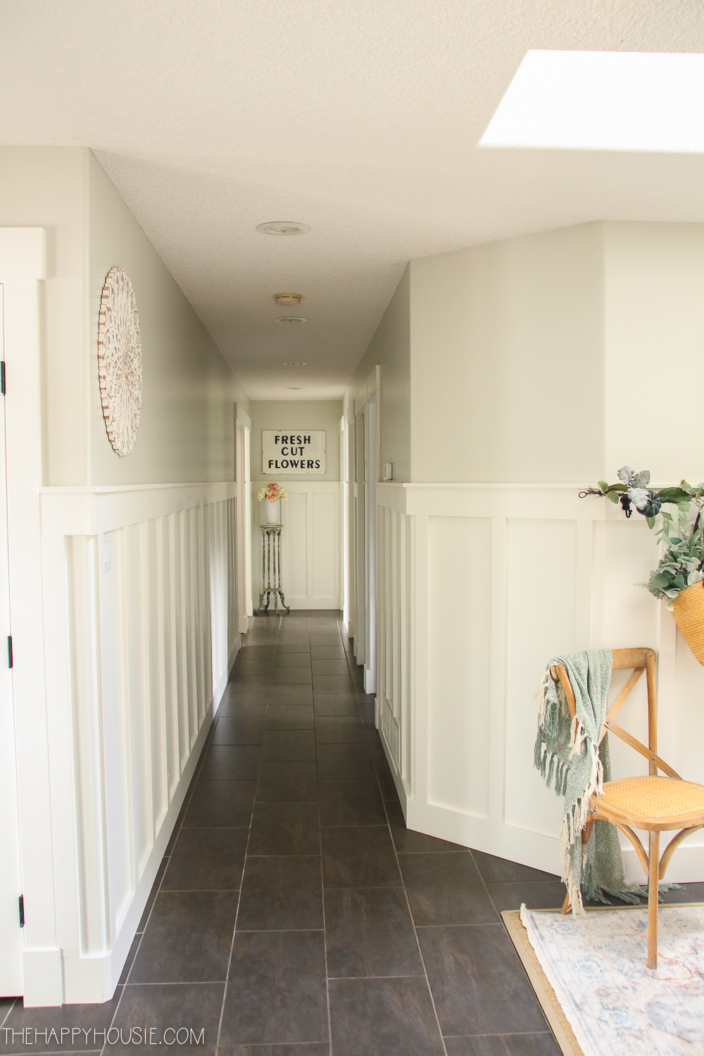 The same hallway painted white with pictures up.