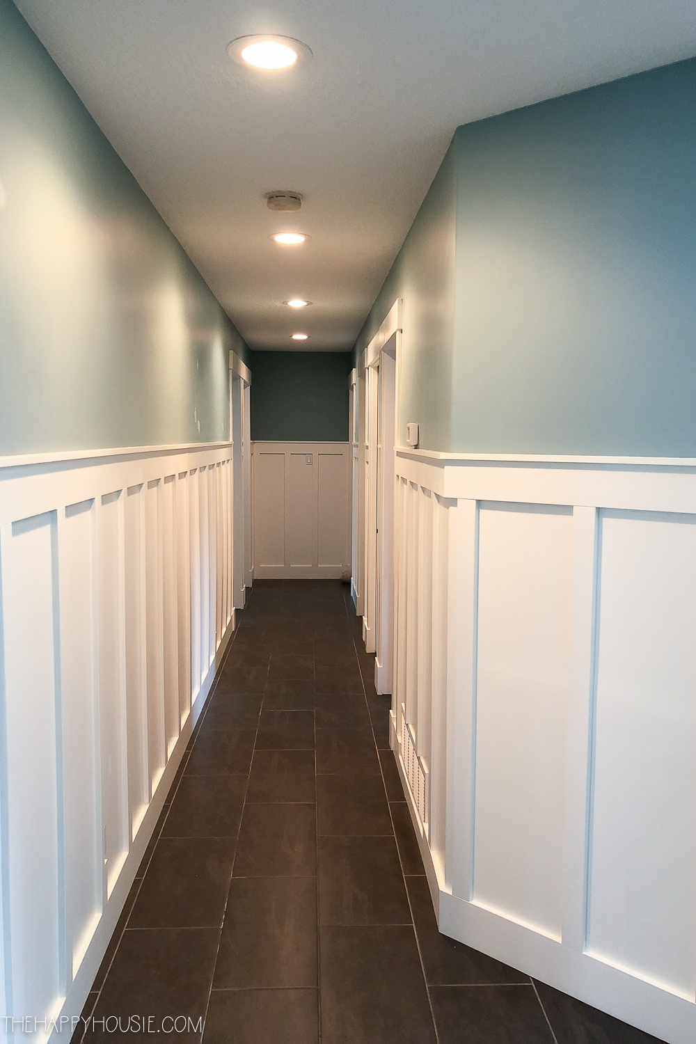 A long undecorated narrow hallway.