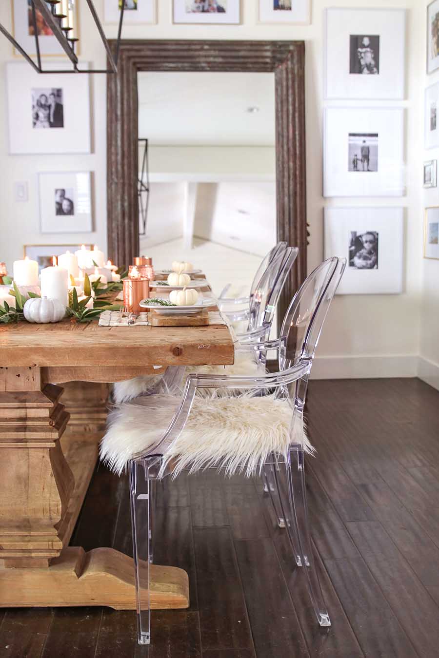 Clear plastic chairs with faux white fur in the dining room.