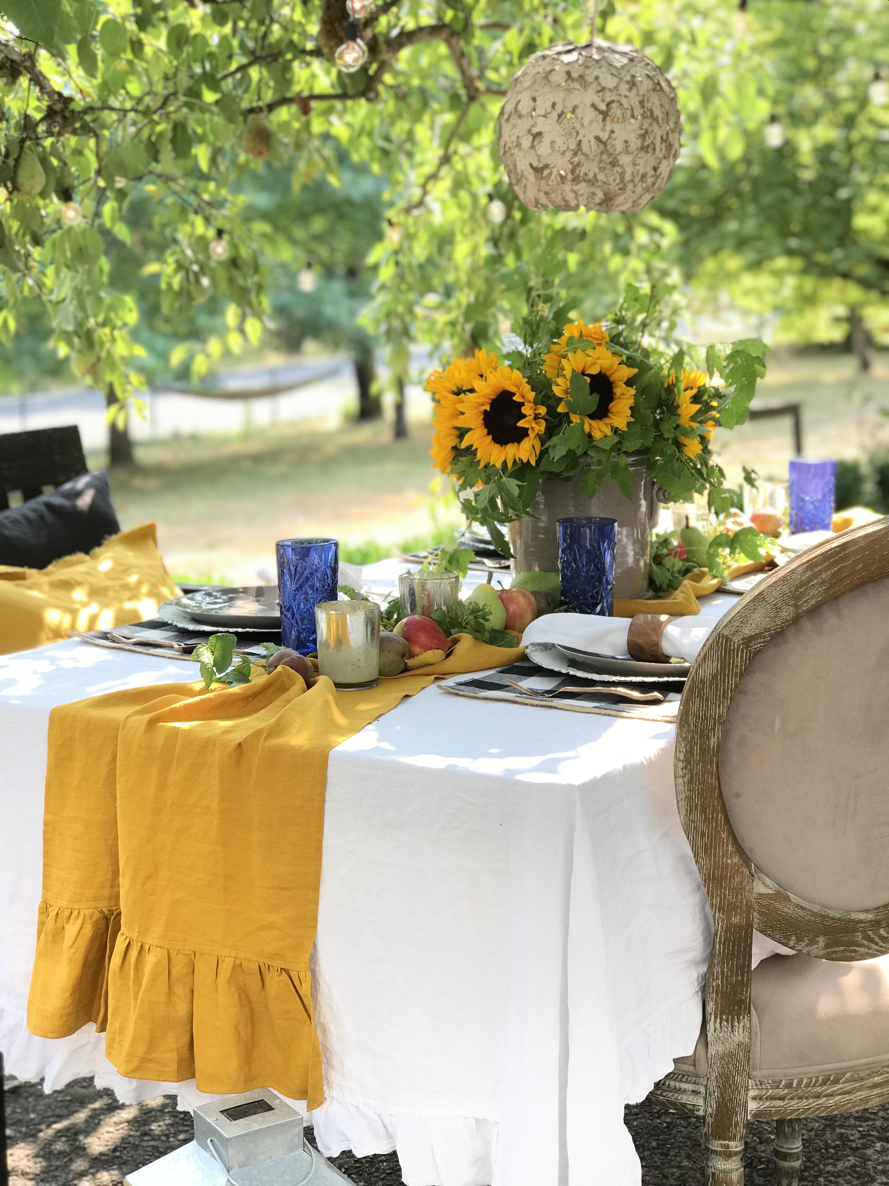 Sunflowers on a dining table outside.