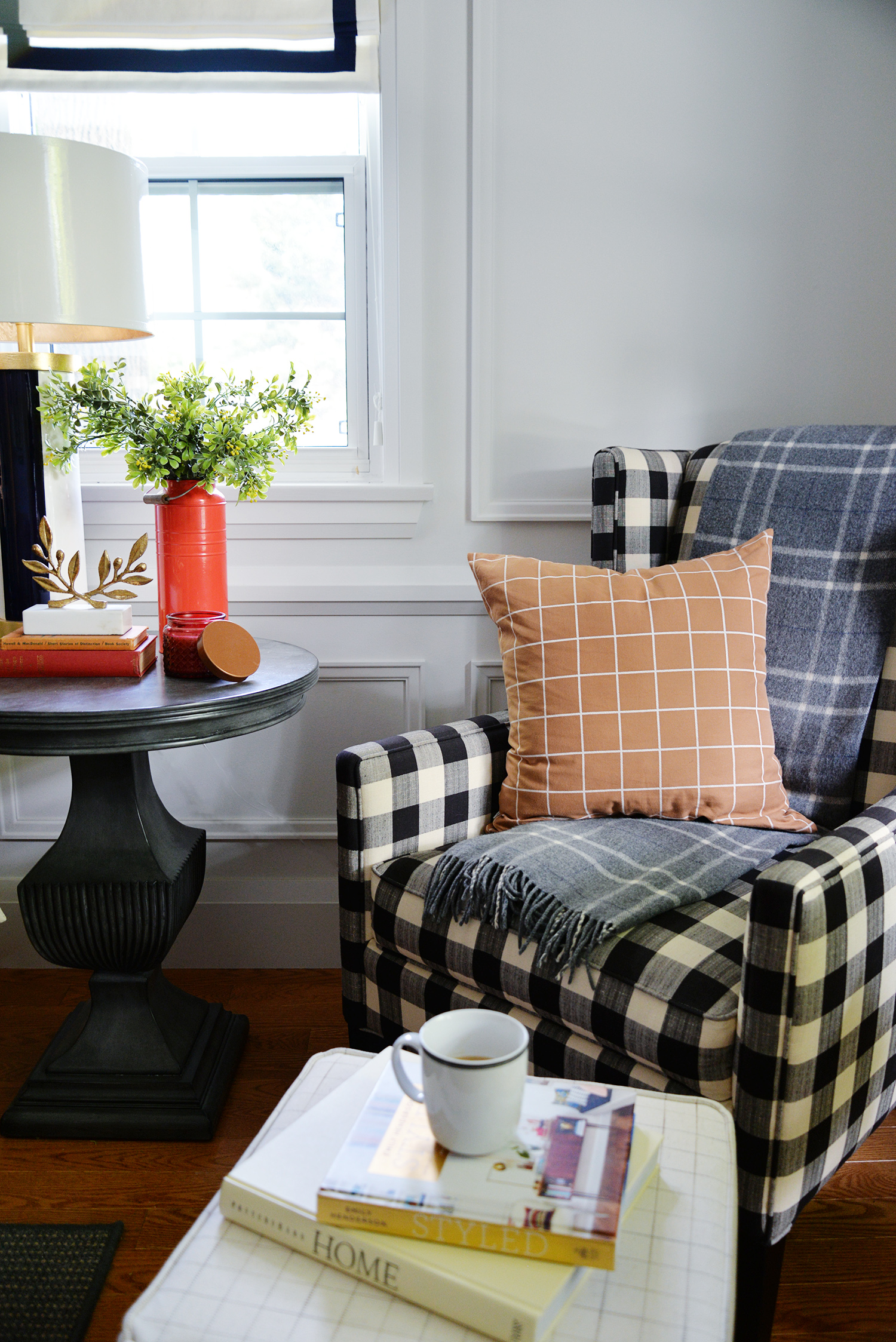Buffalo checked armchair in the corner of a room.