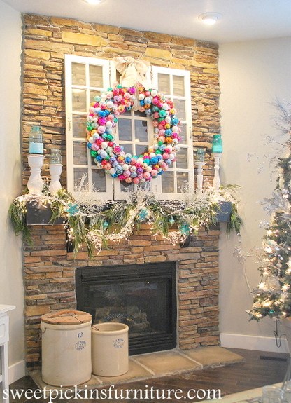 A colourful ball wreath above a fireplace.