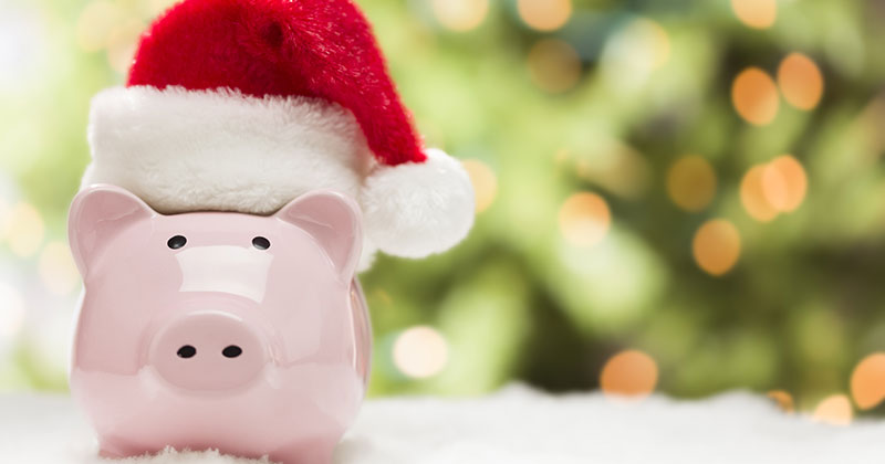 A piggy bank with a santa hat on it.