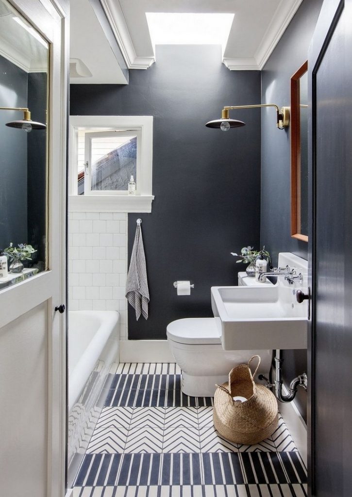 Dark blue walls, with a blue and white patterned bathroom floor.