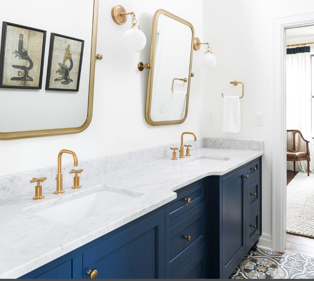 Dark blue bathroom cabinet with gold mirrors.