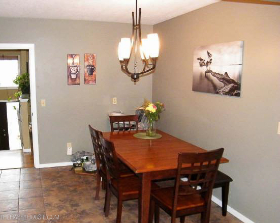 a small dining area painted green with tile floors before being renovated 