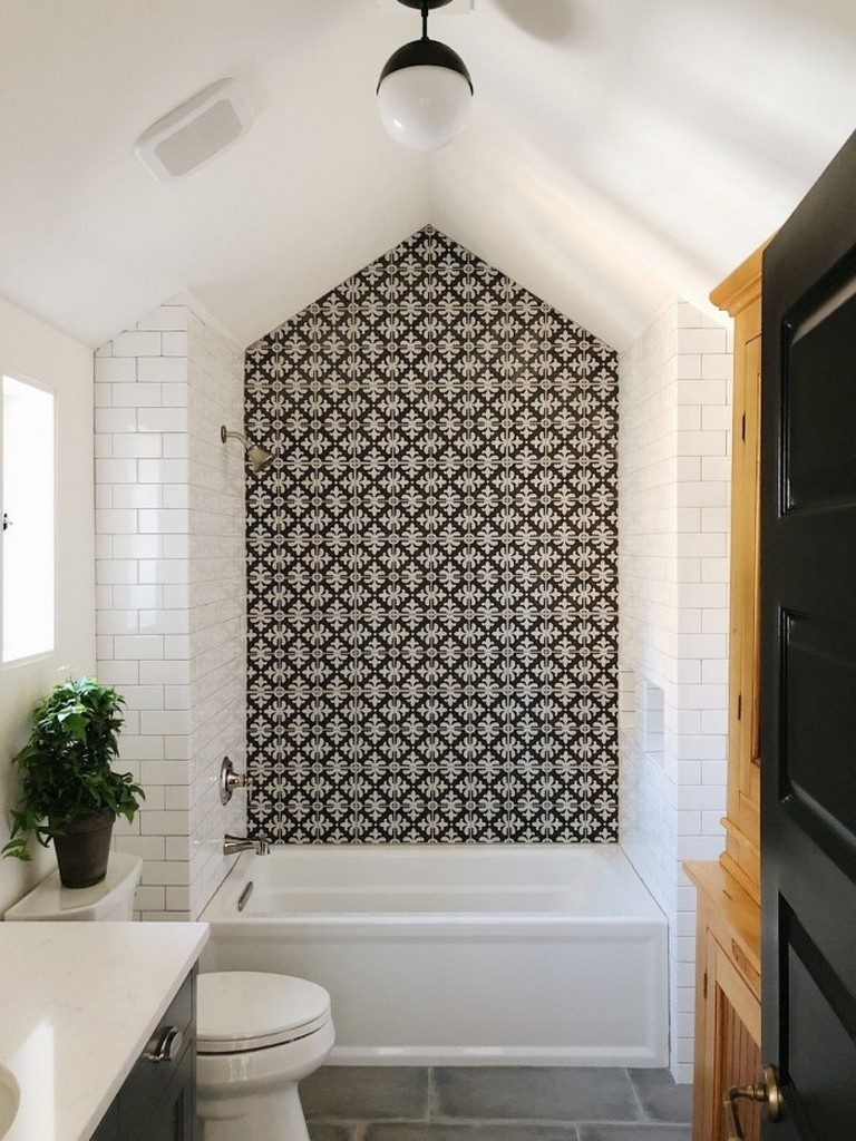 A large patterned intricate tile behind the bathtub.