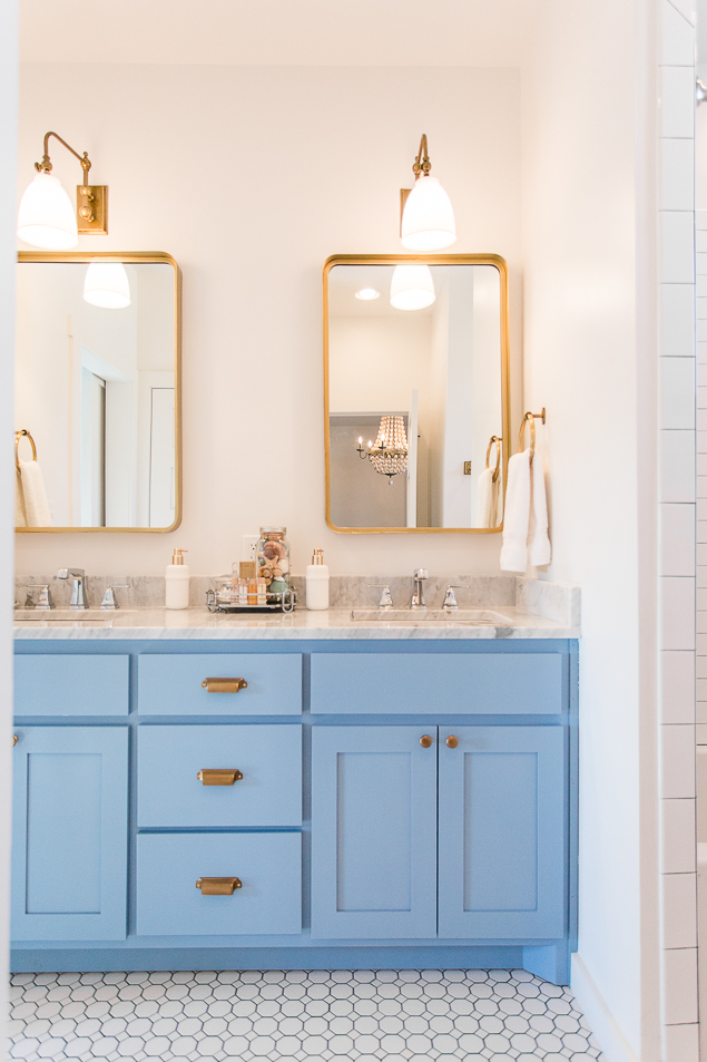 Rectangle gold mirrors and a brighter blue cabinet.