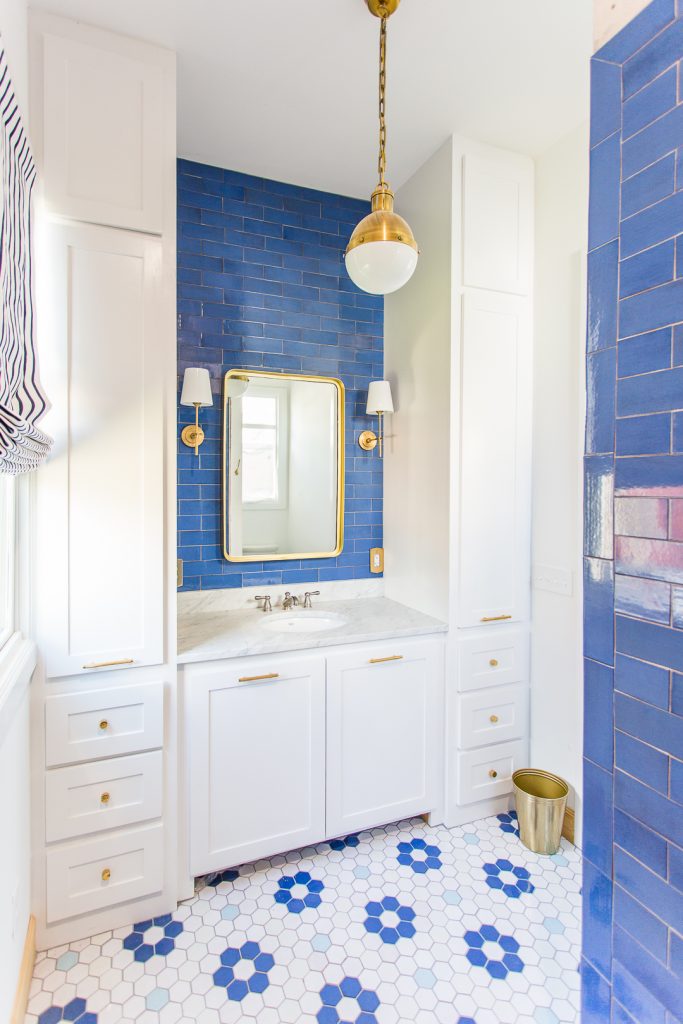 A floral patterned with pops of blue in this bathroom.