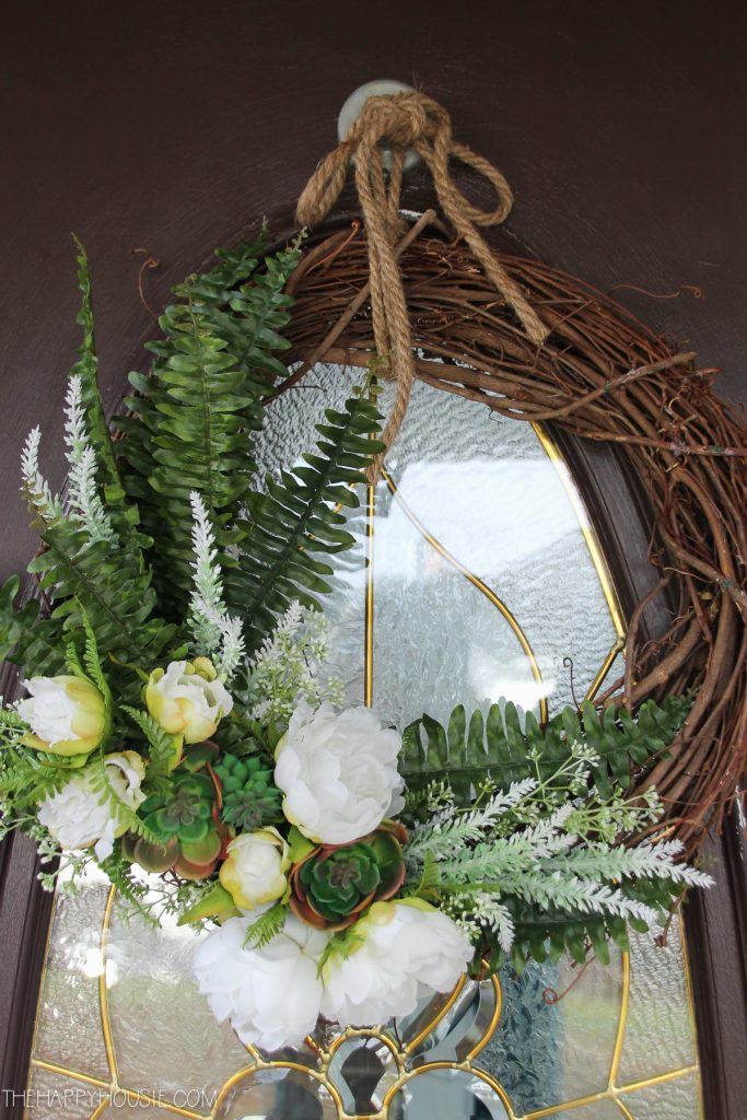 A spring wreath hangs on the front door.