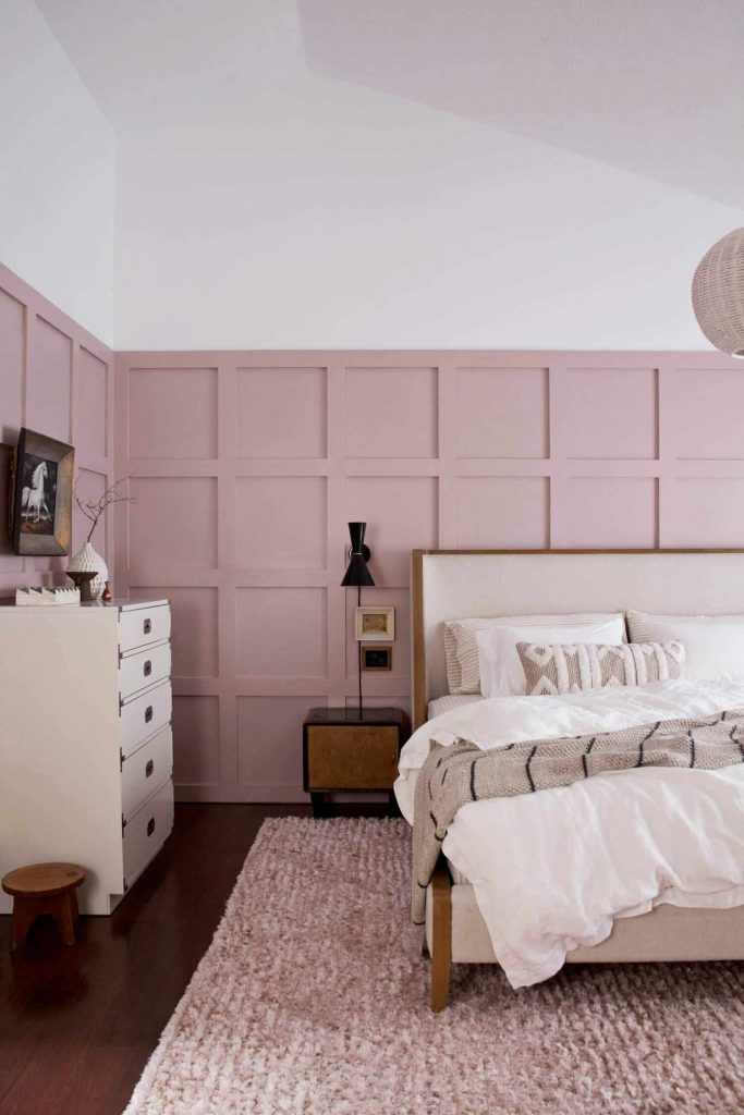 Pink panelled walls in a bedroom.