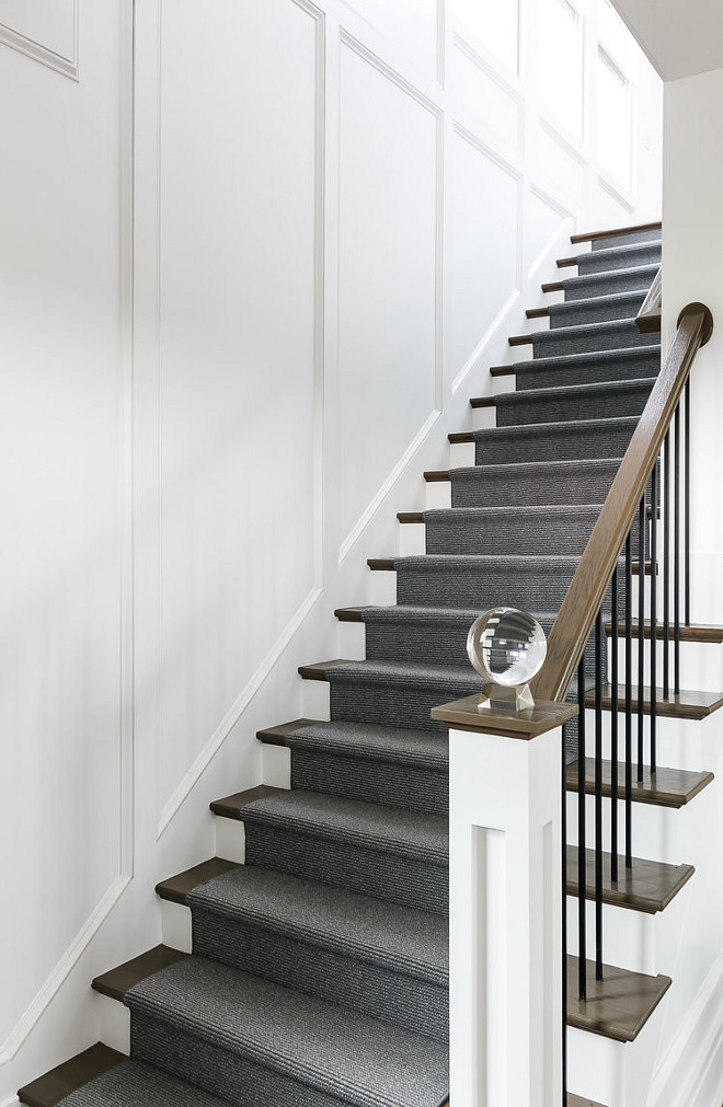 White panelled walls leading up a staircase.