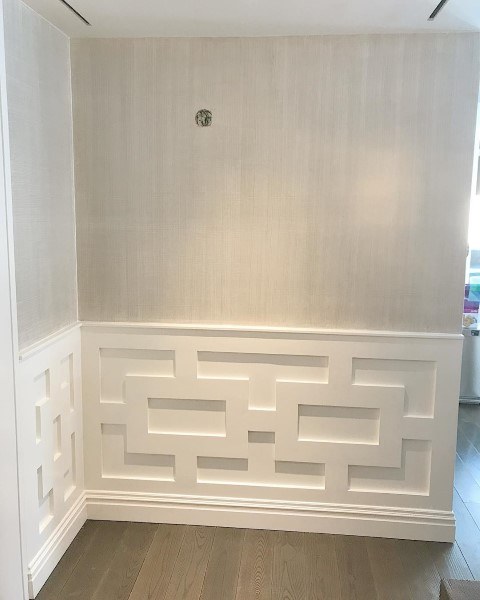 A distinctive patterned white panelled wall.