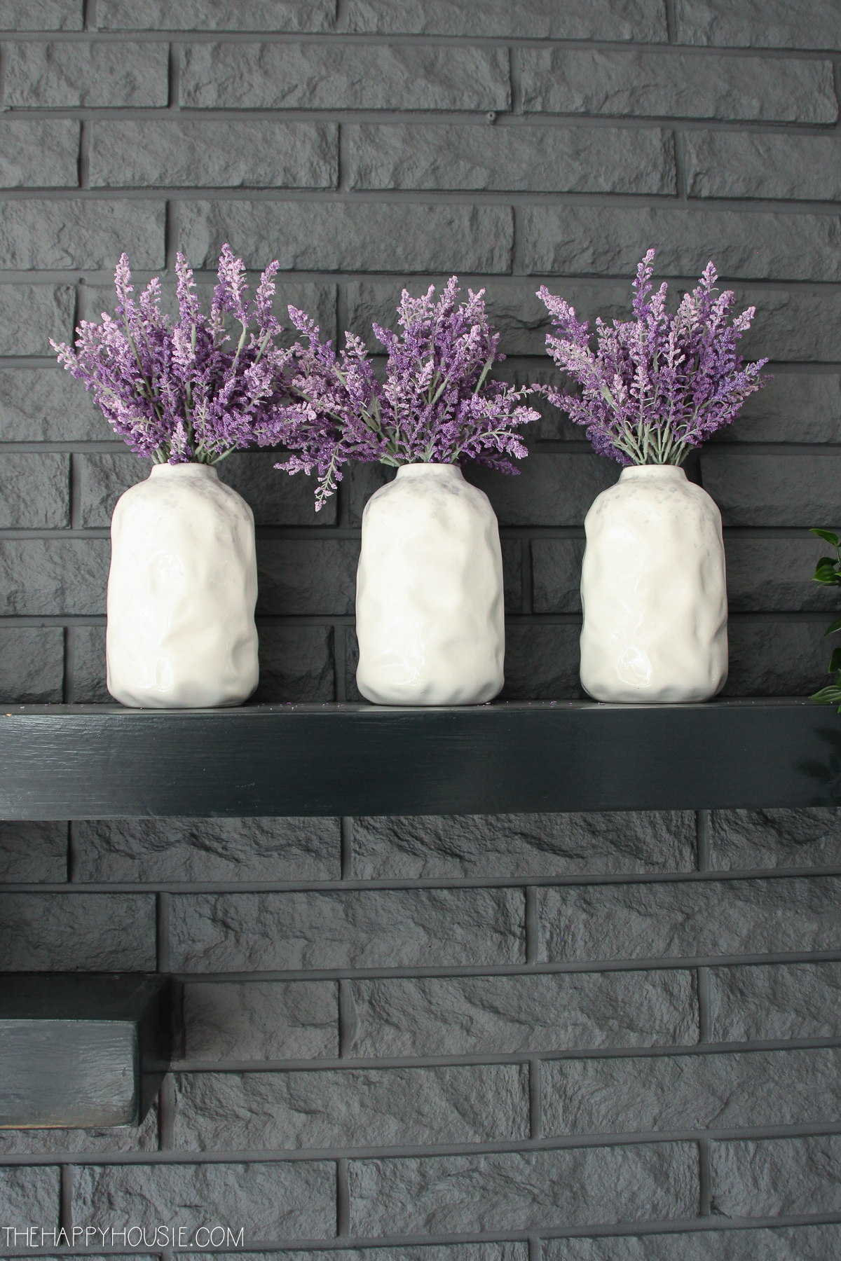 Lavender in white vases on the mantel.