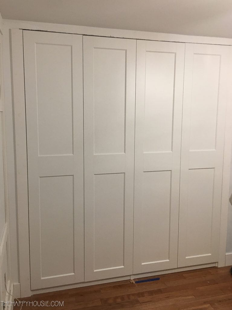 The white simple closet doors in the bedroom.