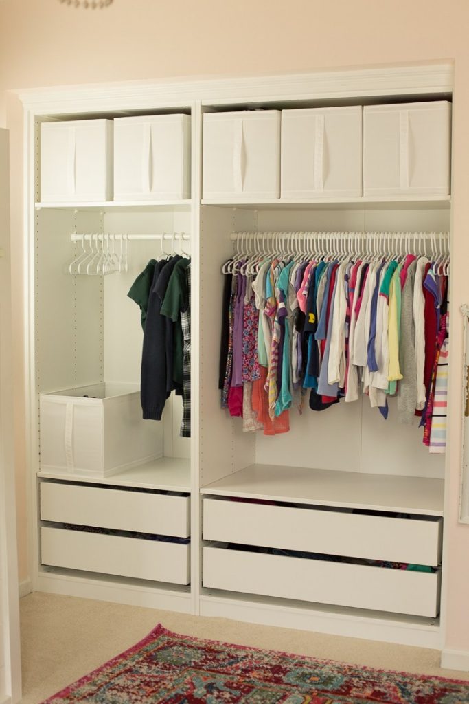 a reach-in style closet uses Ikea PAX wardrobe units to create an organized closet space and clothing storage for children 