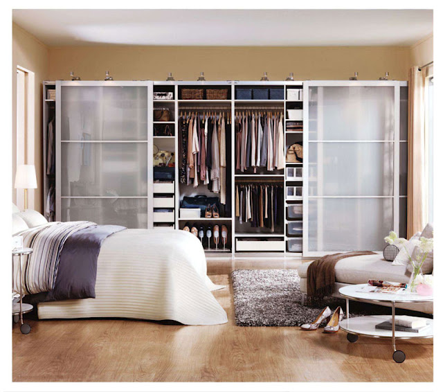an image of an Ikea PAX wardrobe system with sliding doors the go across a full wall to provide a large amount of organized clothing storage