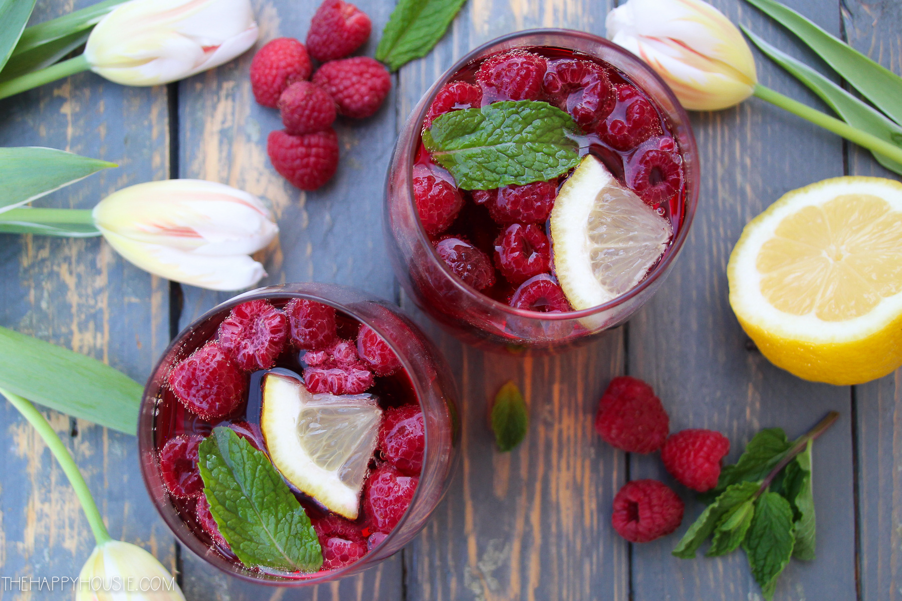 The wine and juice is added to the berries in the glass.