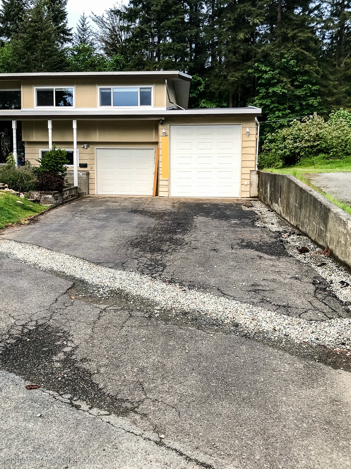 The driveway before renovation with cracks in it.