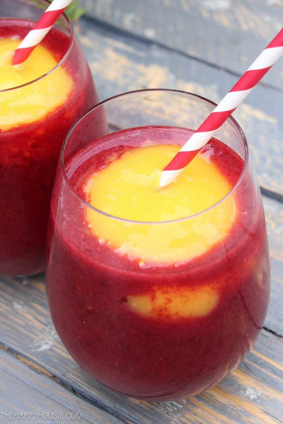 There are red and white straws in the drink.