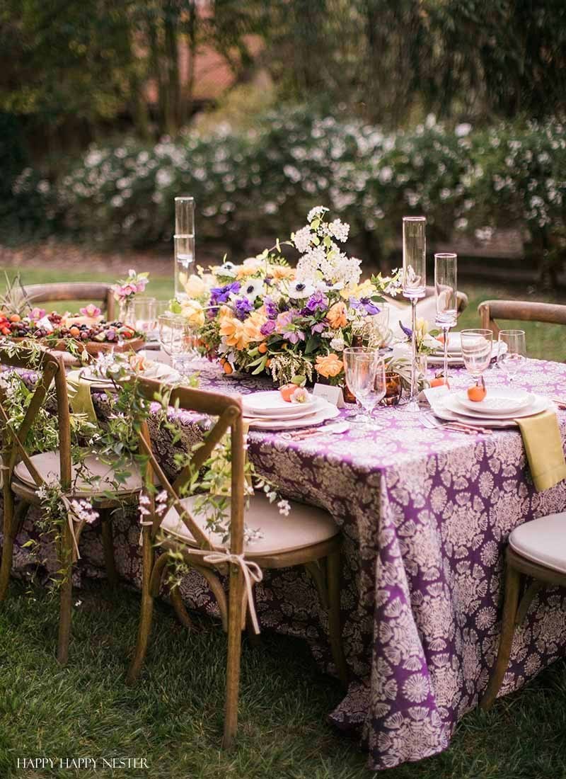 A table set up in the backyard with fresh flowers.