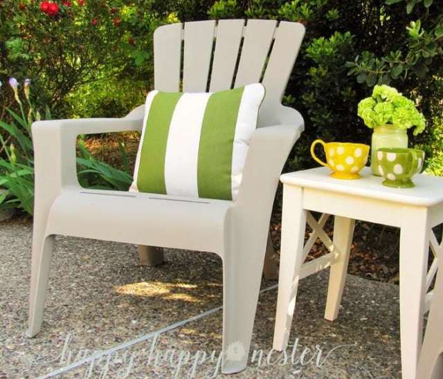 A plastic outdoor painted chair with a green and white pillow.