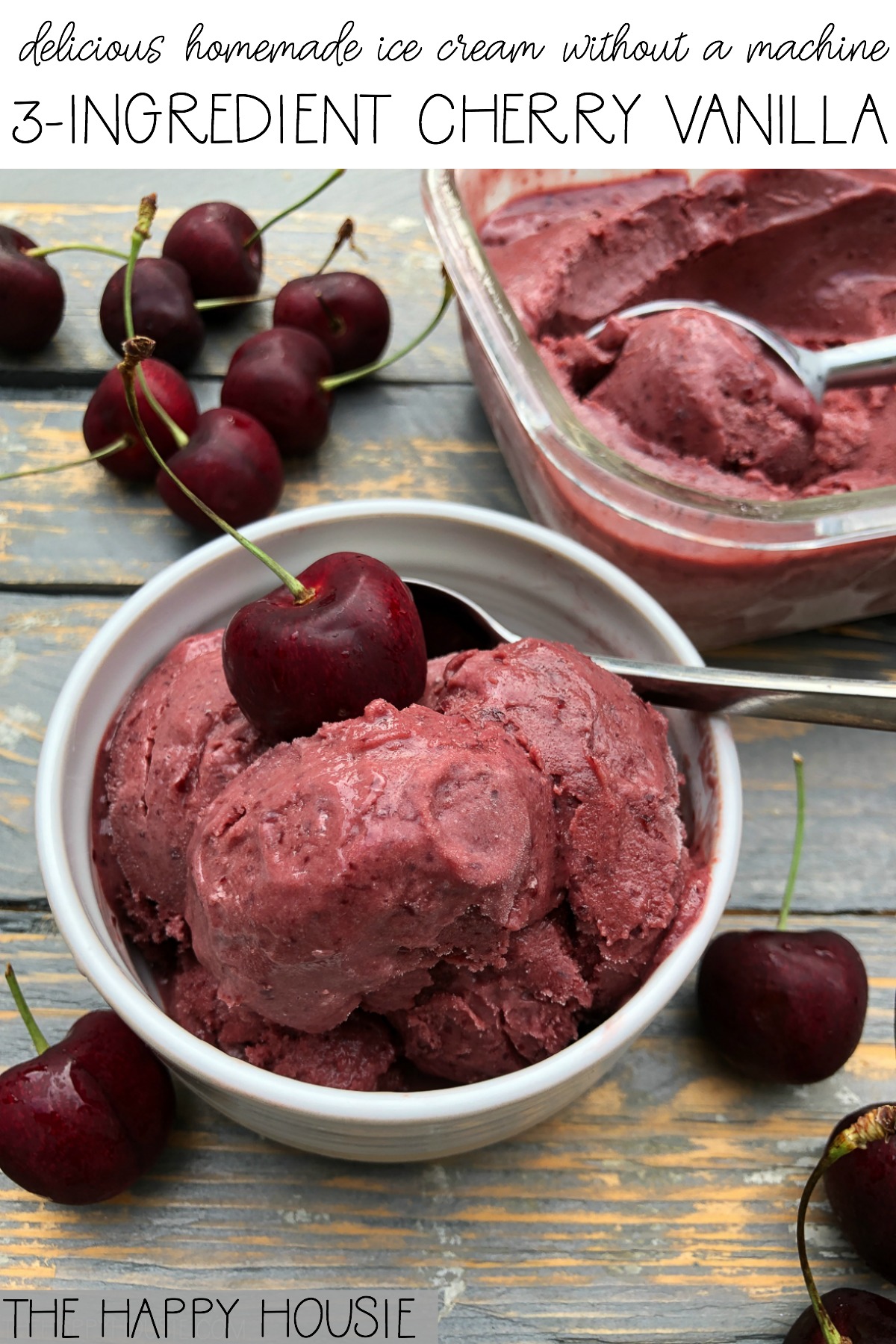 A white bowl filled with cherry vanilla ice cream and cherries beside it.