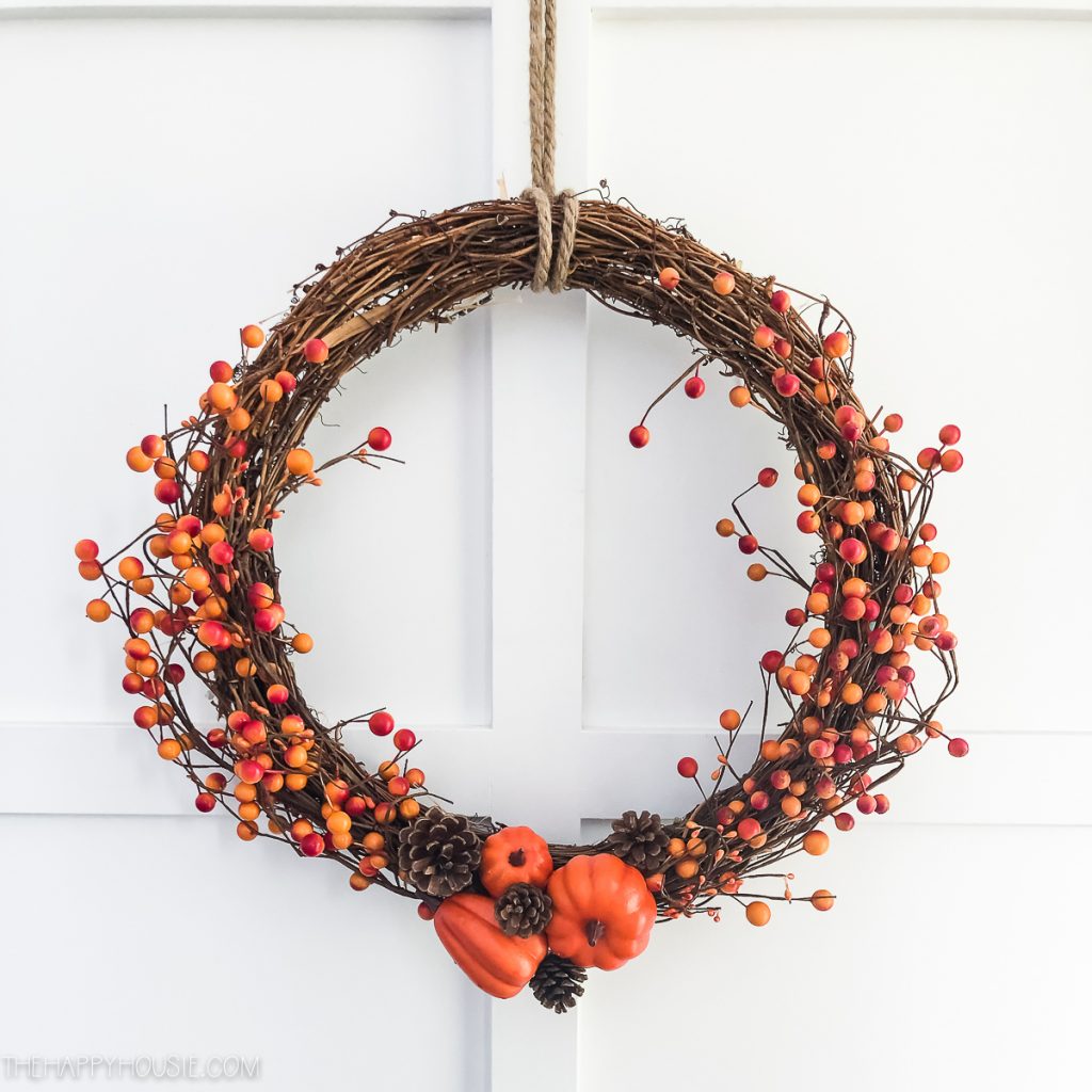 Beautiful DIY Thanksgiving wreaths adorned with autumn leaves, pumpkins, and berries.