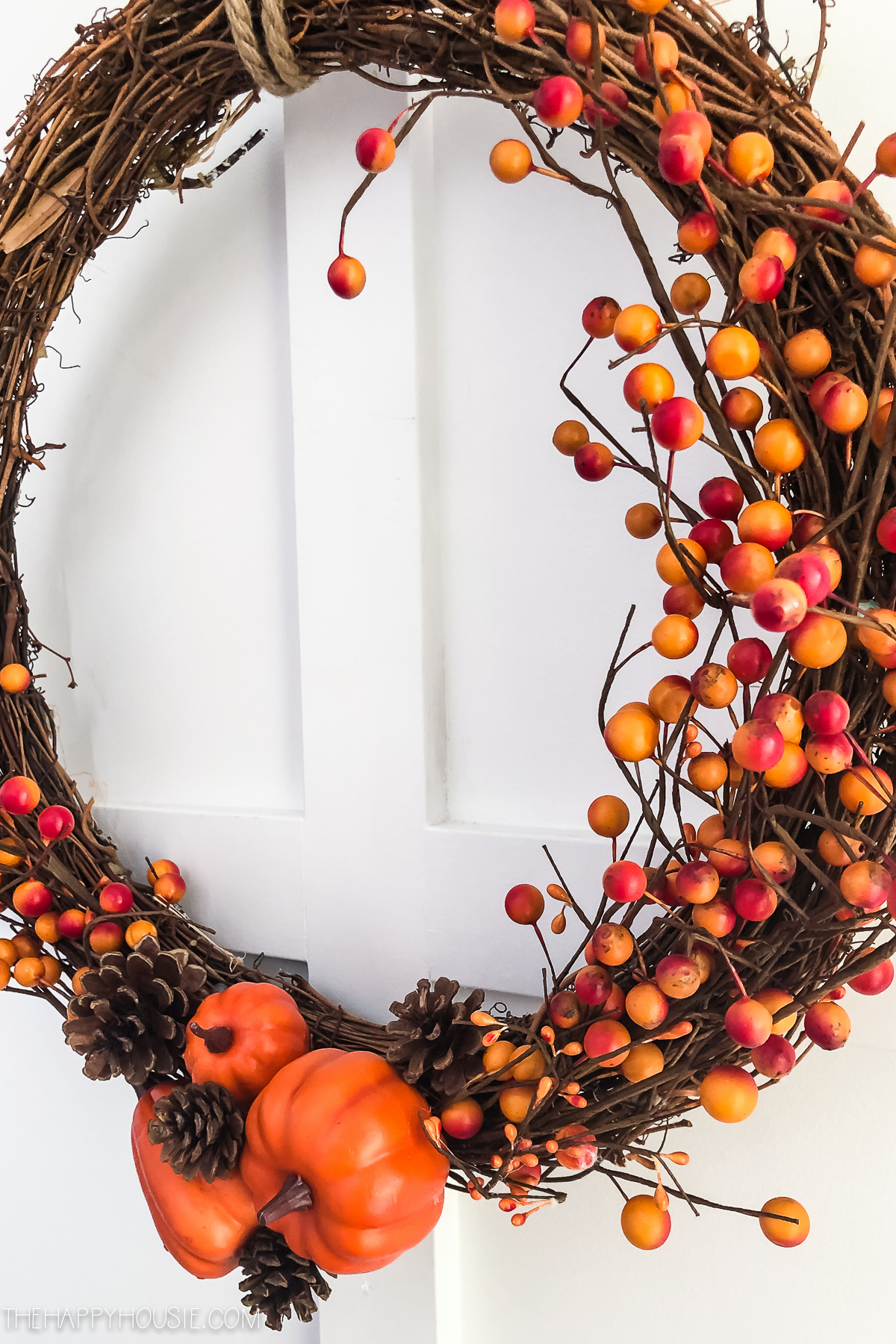 The orange and red berries, pine cones, pumpkins on the wreath.