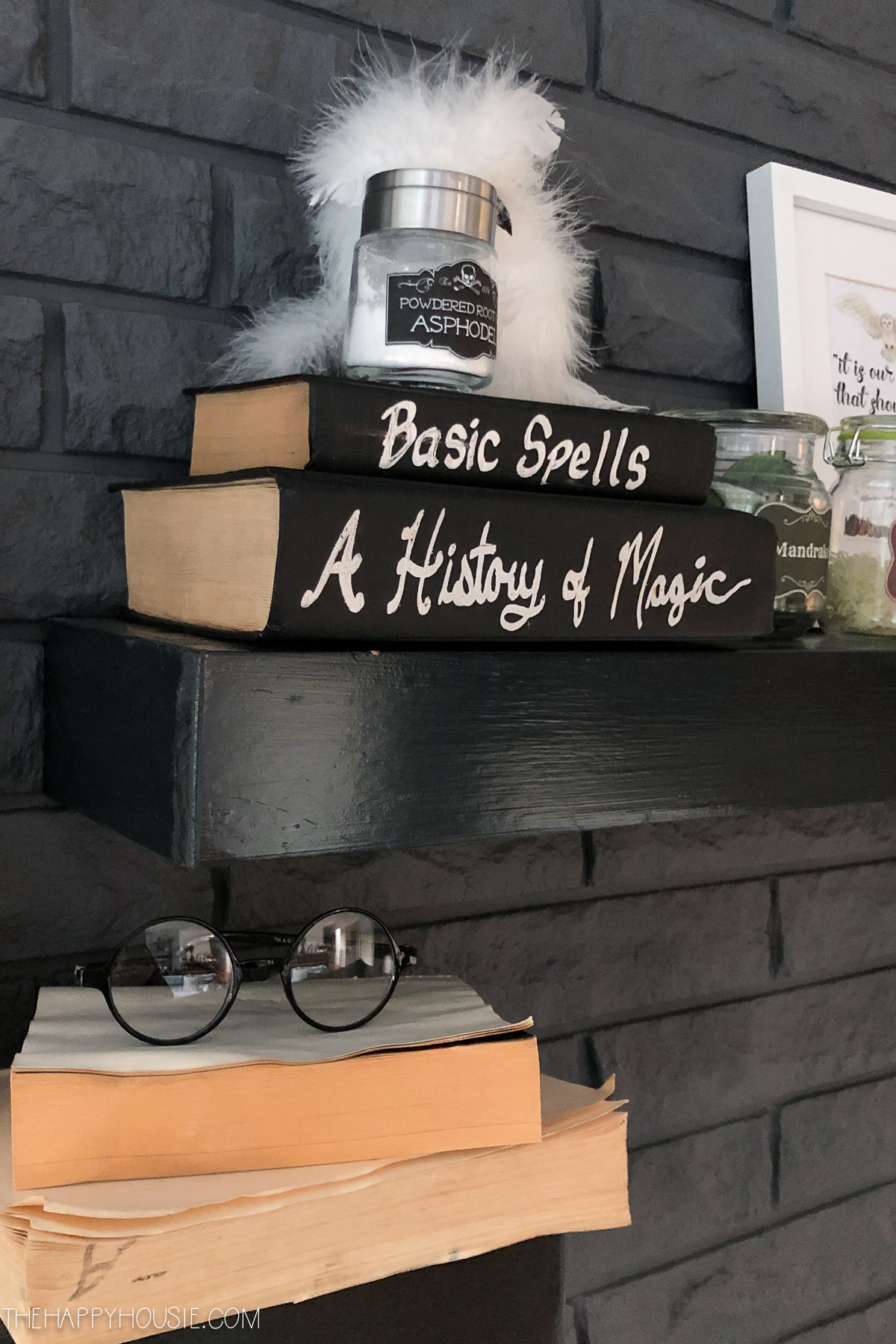 There are Harry Potter glasses sitting on the books.