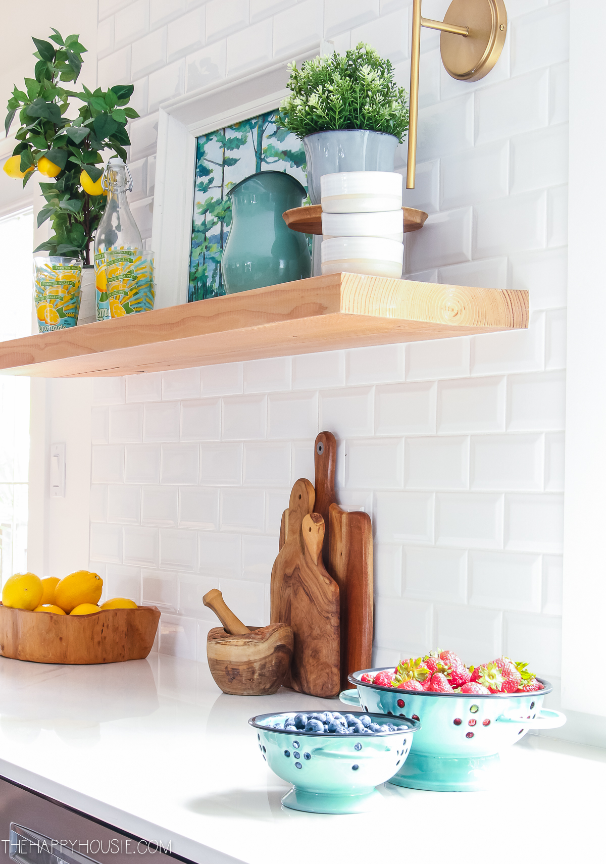 Wooden cutting boards are leaning against the white tile in the kitchen.
