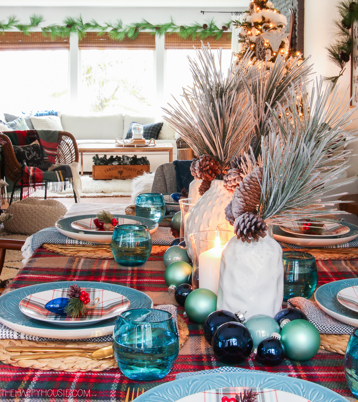 A table set for Christmas with a plaid tablecloth, and plates.