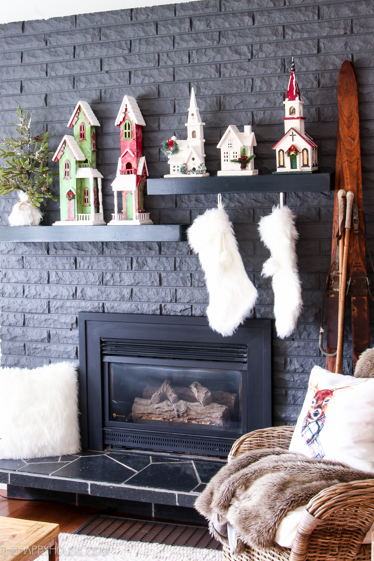 Little village houses on shelves above the fireplace.