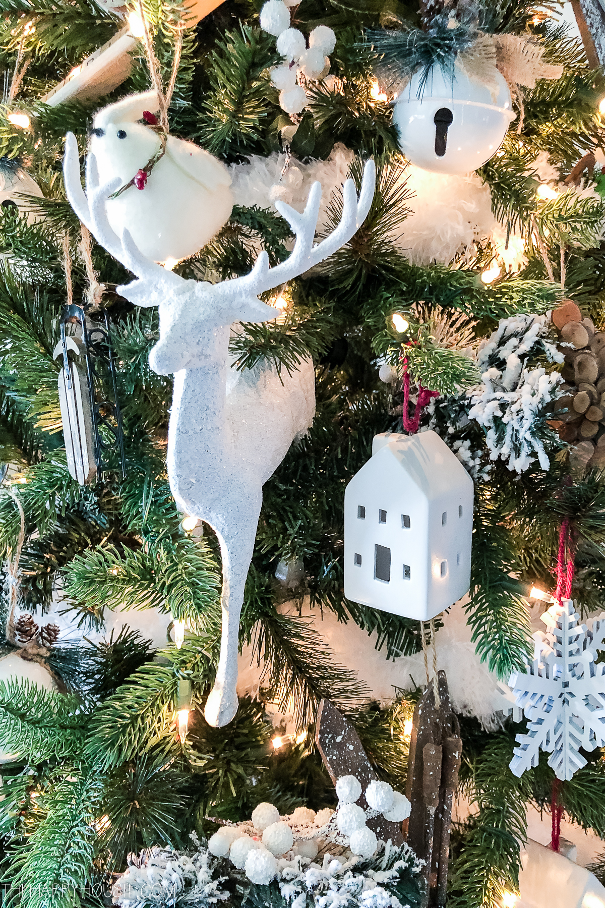 A small white Scandi deer is on the tree.