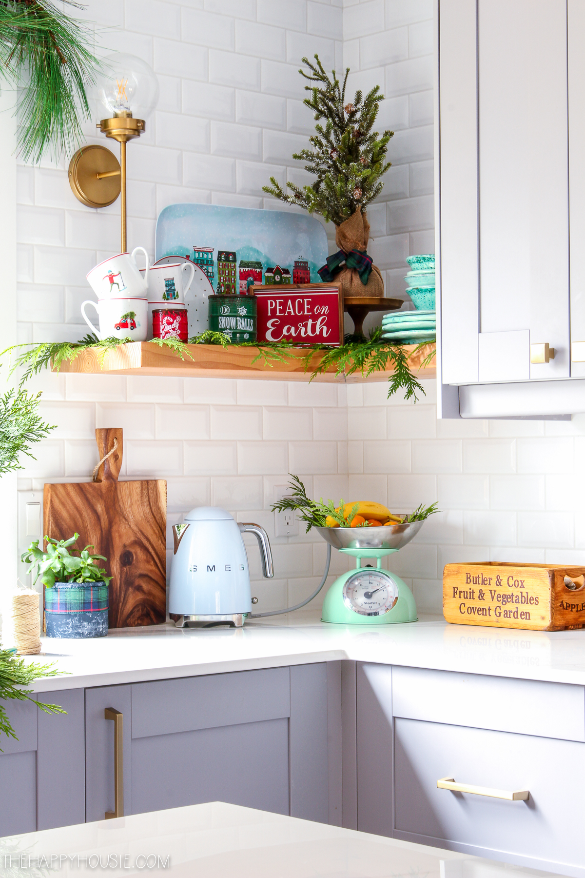 There is another open corner shelf in the kitchen with holiday decor.