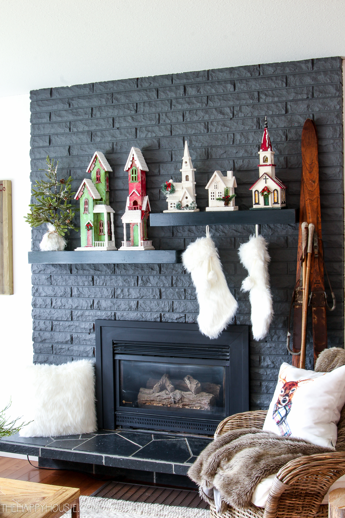 White faux fur stockings are hanging above the fireplace.