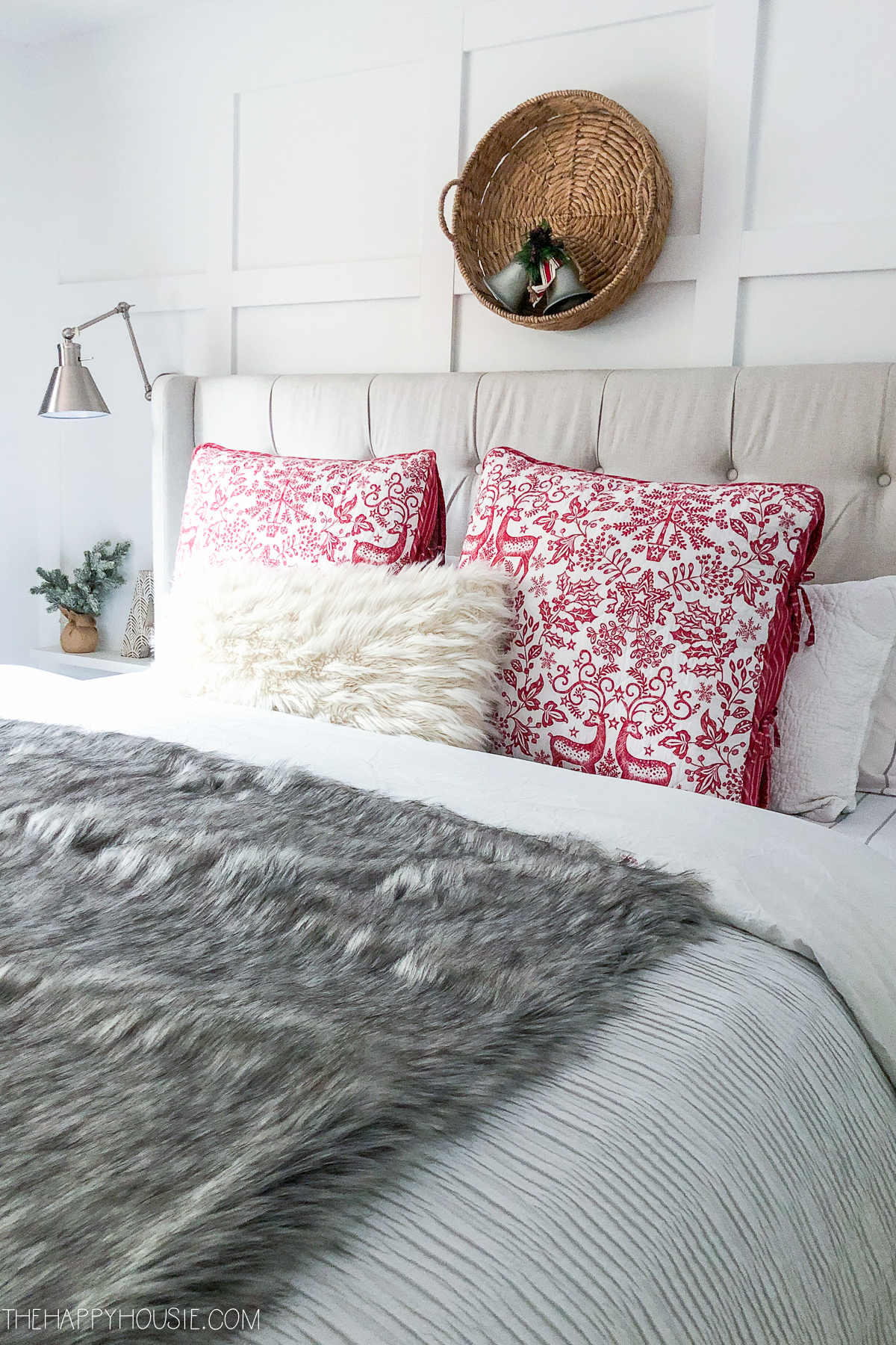 Red and white throw pillows are on the bed.