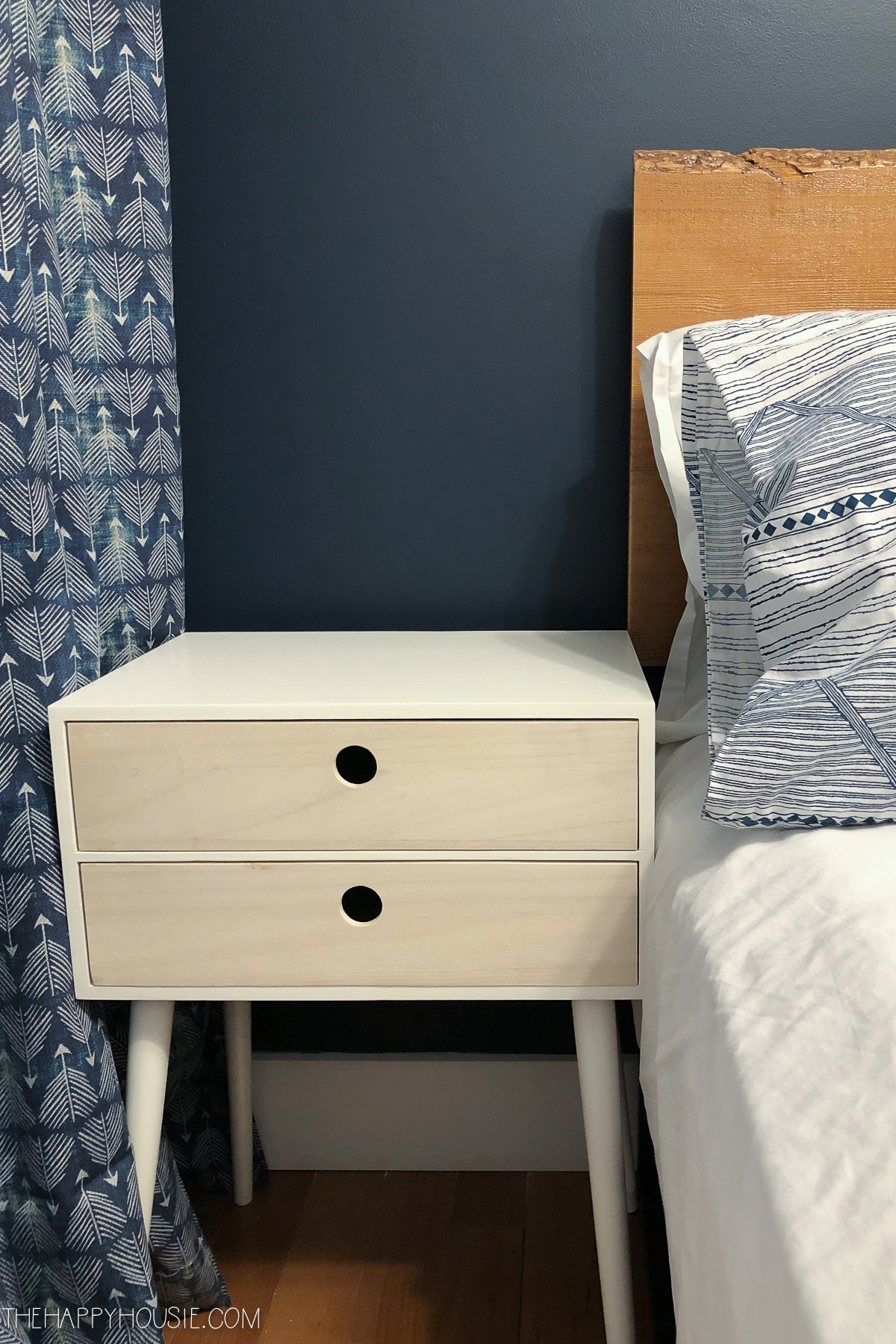 A small nightstand beside the bed.