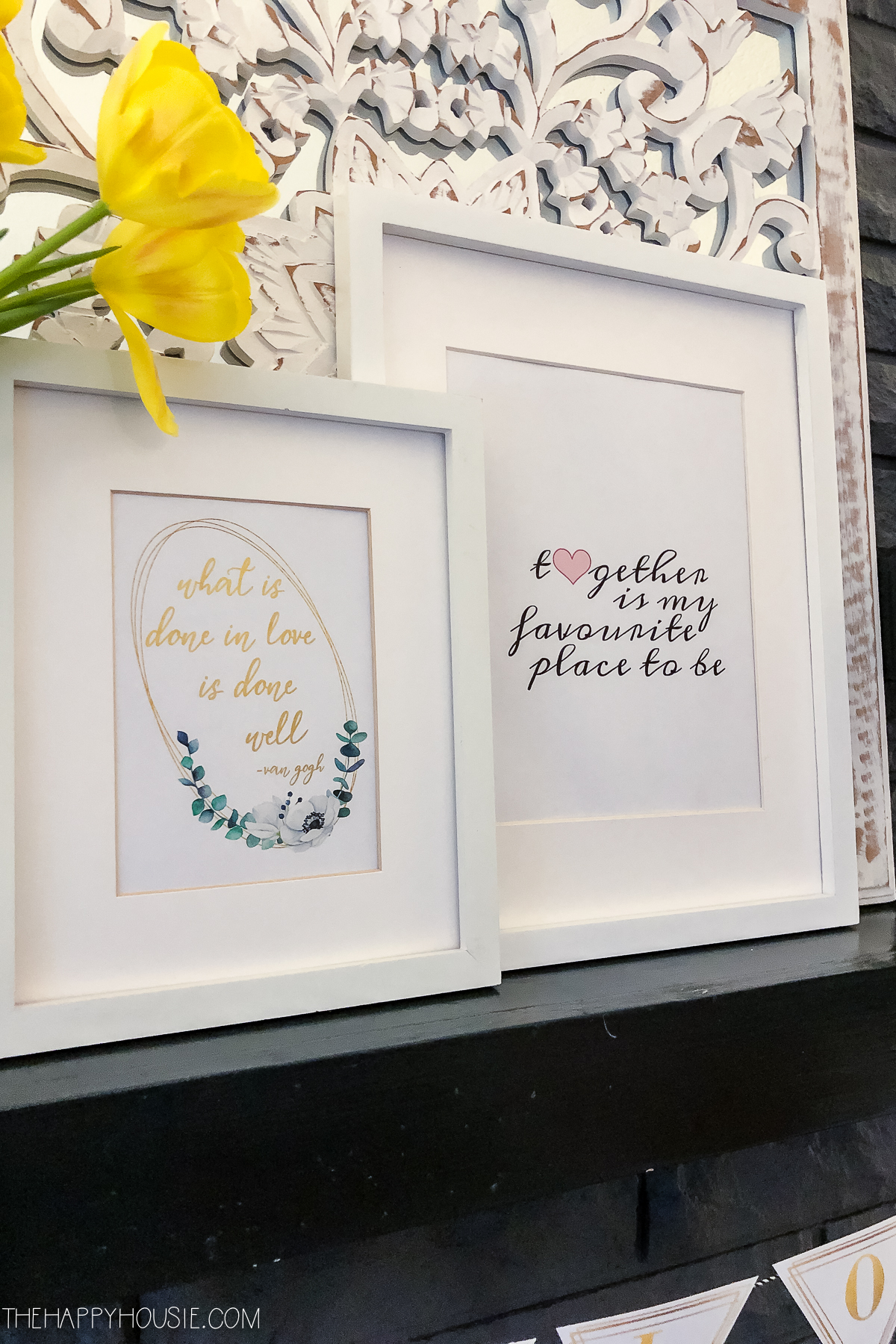 The framed quotes and yellow flowers.