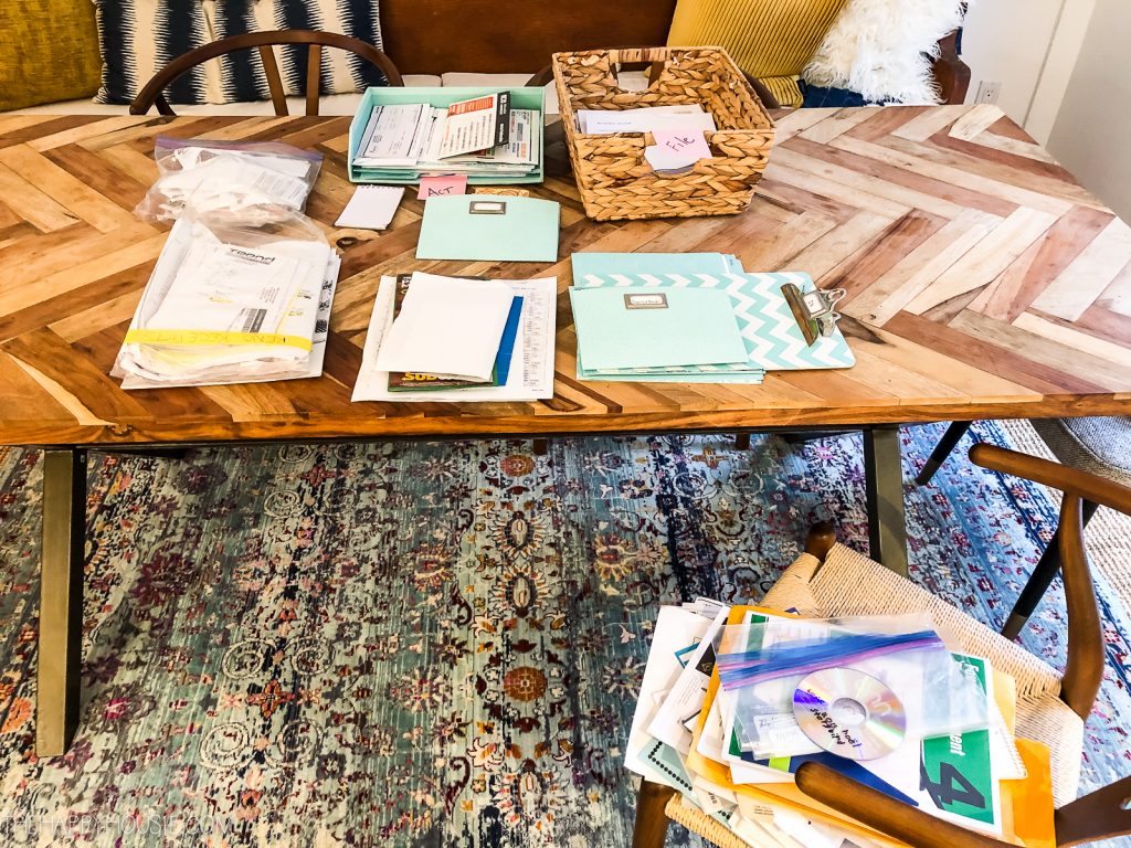 All the paperwork in piles on the table.